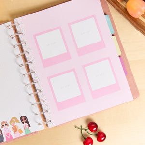 Notebook with pink decorative pages on a wooden surface