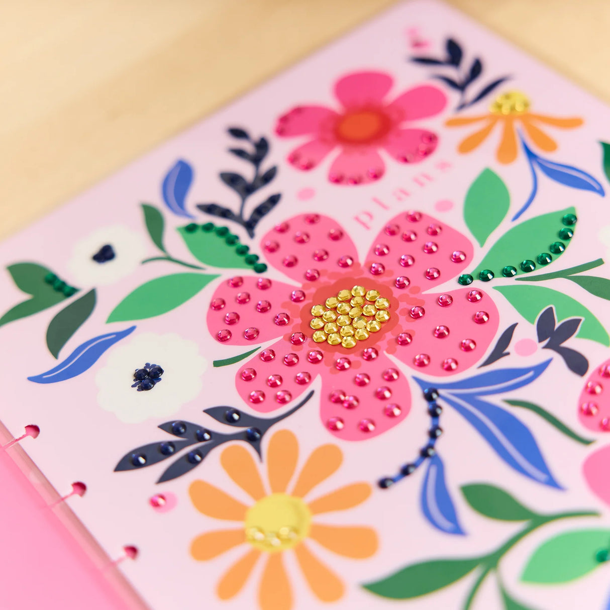 Floral design with pink flowers and green leaves on a pink background