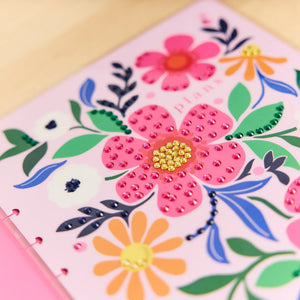 Floral design with pink flowers and green leaves on a pink background