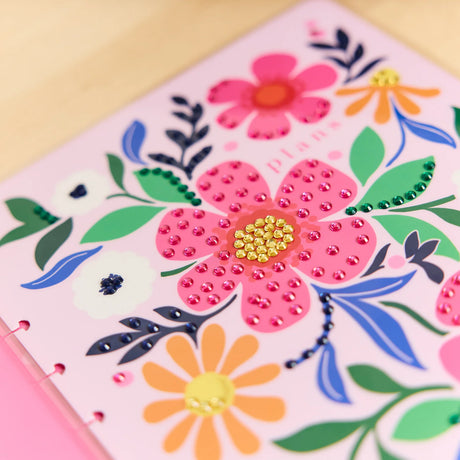Floral design with pink flowers and green leaves on a pink background