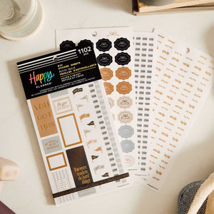 Haven & Heart Fitness sticker book beside workout reminder and tracking sheets on a desk