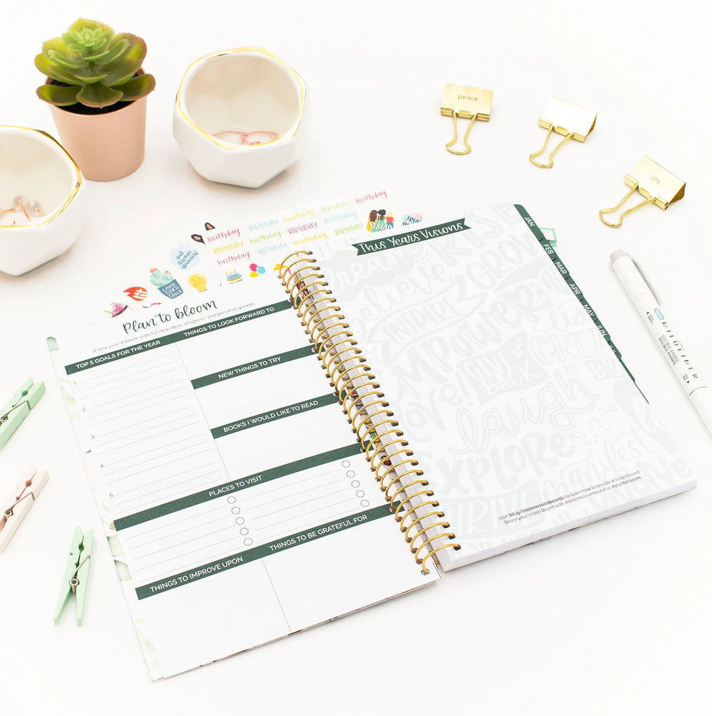 Open planner with a to-do list on a white surface with decorative items.