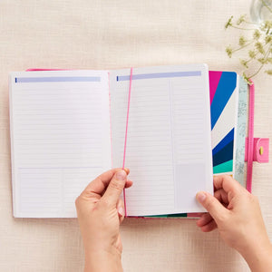 Erin Condren planner folio: Hands opening a Petite book held by the folio elastic band
