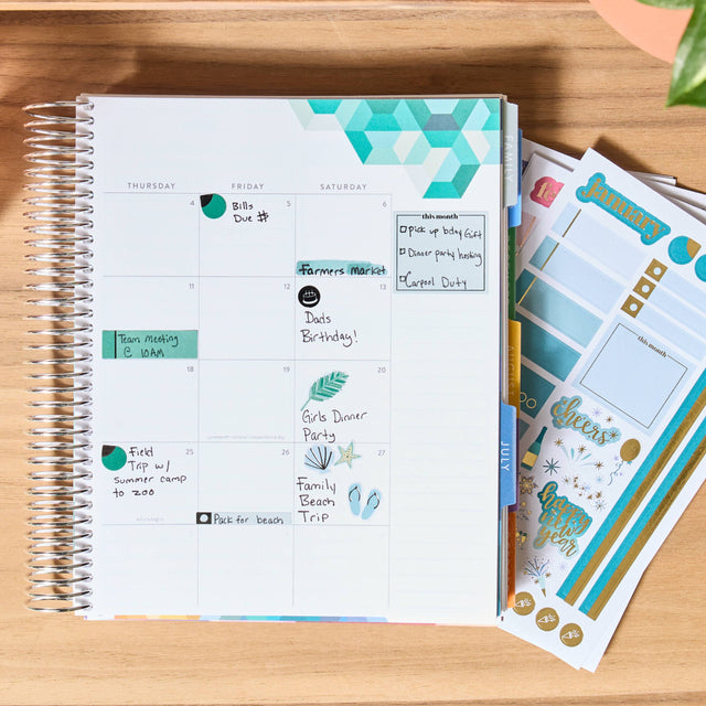 Planner with stickers on a wooden surface