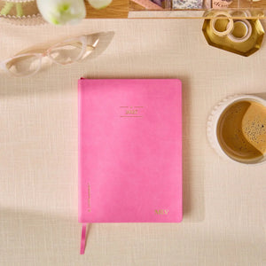 Erin Condren LifePlanner: Closed Candy pink Softbound LifePlanner on a desk