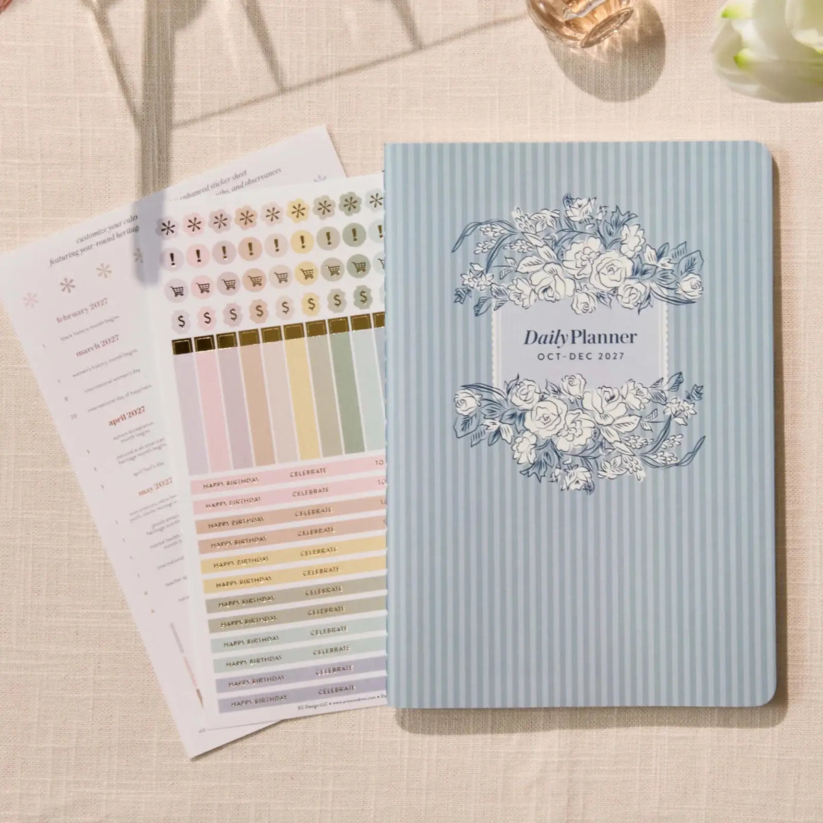 Erin Condren Petite Planner: Quarterly planner cover beside included sticker sheets