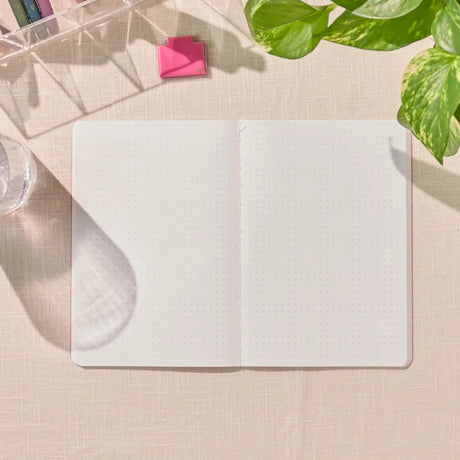 Erin Condren Petite Journal: Open dot grid journal on a desk