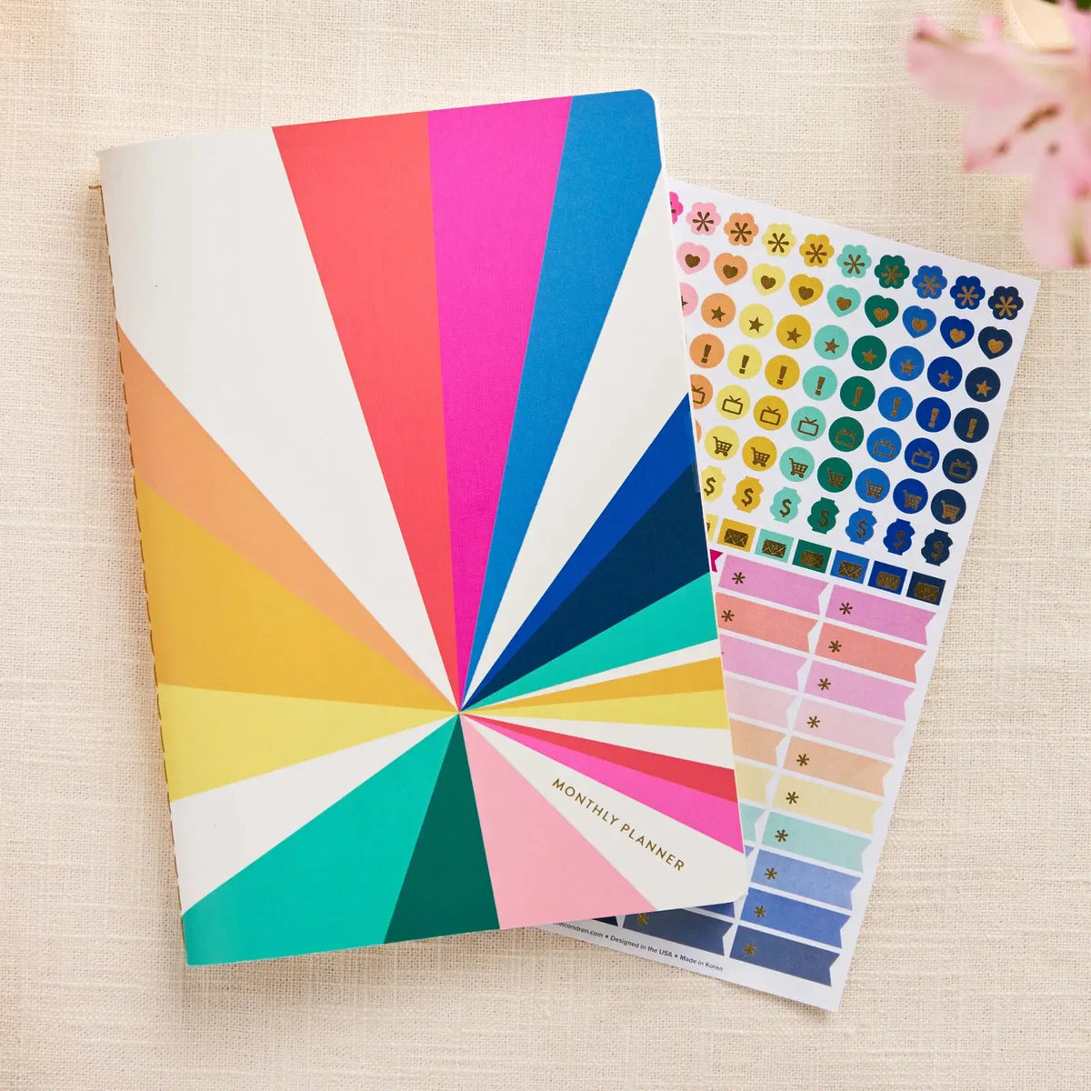 Erin Condren Petite Planner: Closed monthly planner beside its sticker sheet