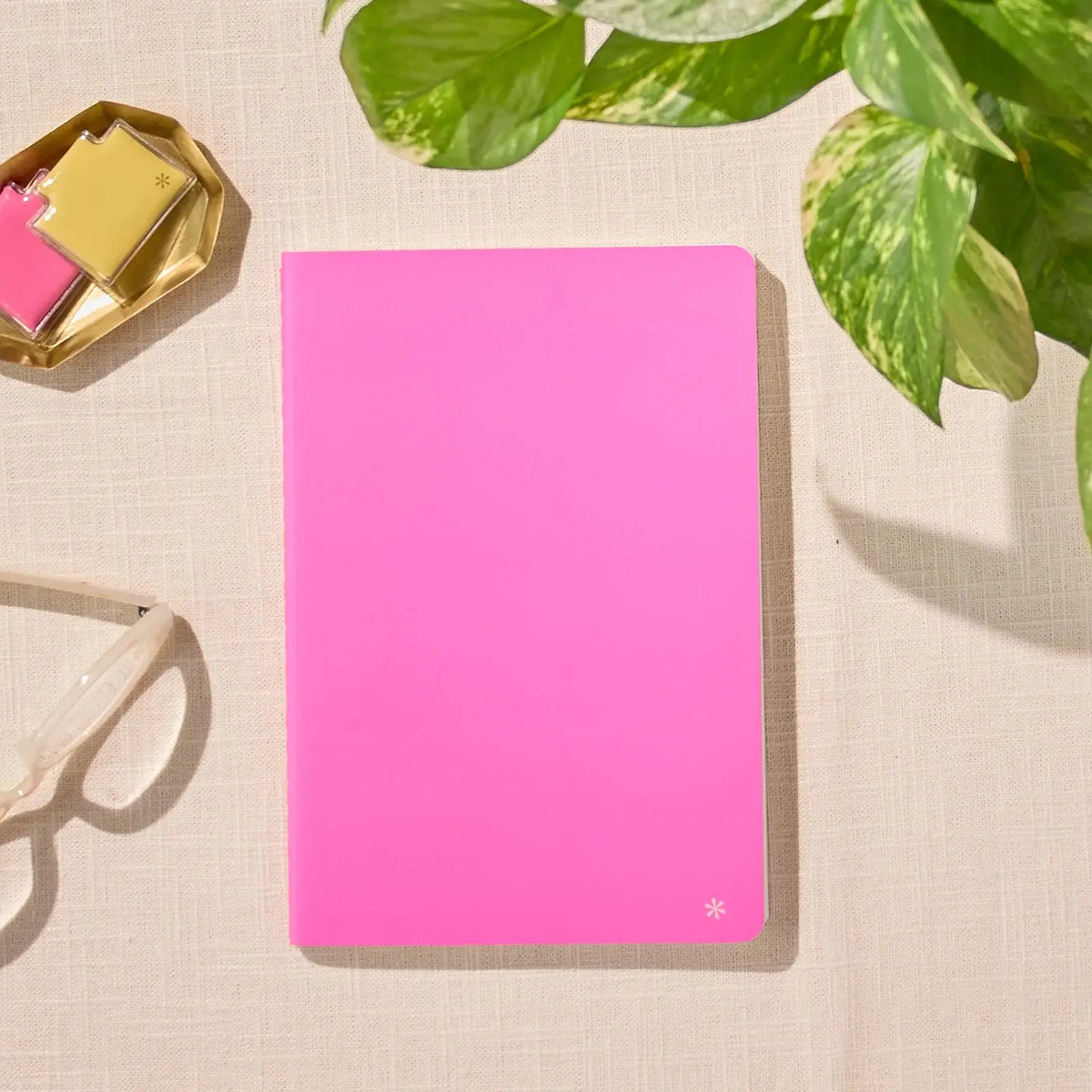 Erin Condren Petite Journal: Closed Candy pink journal on a desk