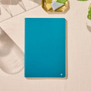 Erin Condren Petite Journal: Closed Peacock journal on a desk