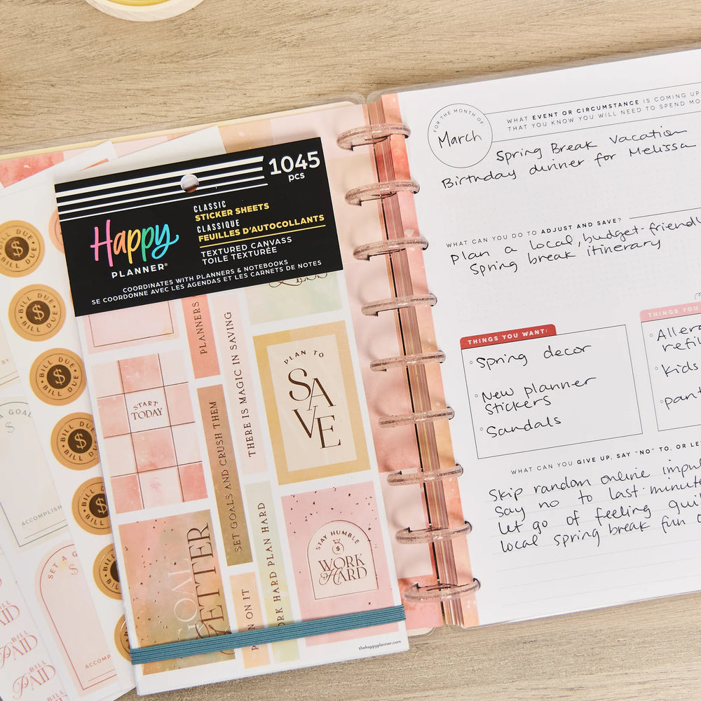 Happy Planner Textured Budget Classic Sticker Book and a planner on a wooden surface