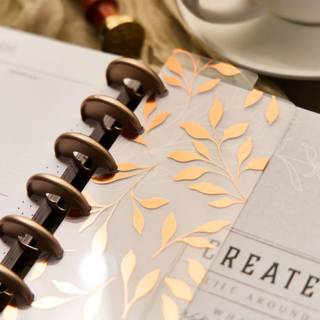 Close-up of a notebook with floral design and spiral binding