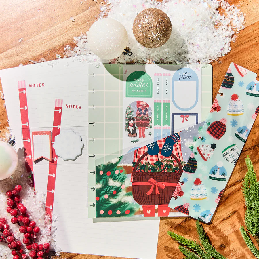 Set of Christmas-themed planner stickers on a wooden surface with decorative elements.