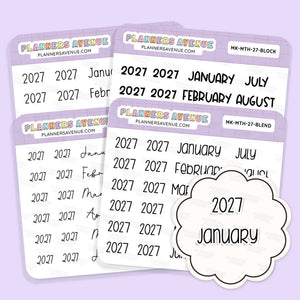 2027 Month & Year Planner Stickers sheets from Planners Avenue featuring the year 2027 in black script on white labels with lavender headers. A cloud-shaped sticker reading '2027 January' is shown in front.