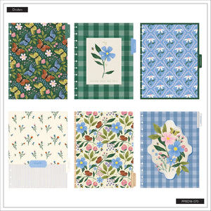 Collection of notebooks with floral and checkered patterns on a white background