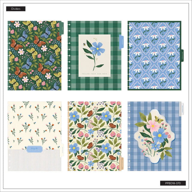 Collection of notebooks with floral and checkered patterns on a white background