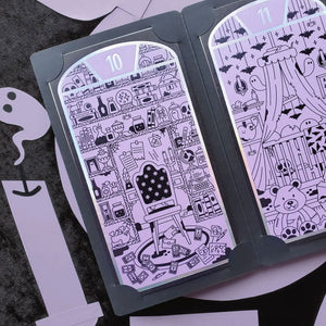 Halloween-themed STICKII with black and white designs on a dark surface.