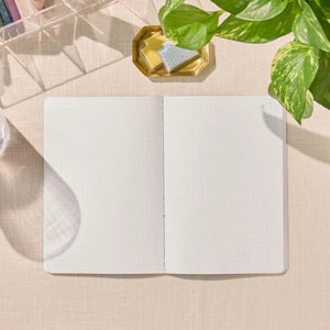 Erin Condren Petite Journal: Open dot grid Petite Journal on a desk