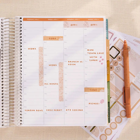 Erin Condren sticker book: Open planner decorated with pastel functional stickers