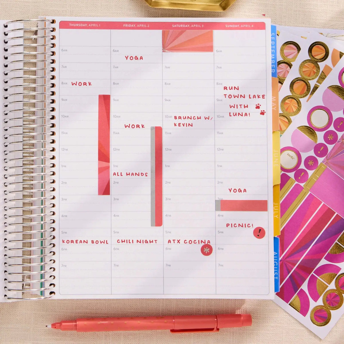 Erin Condren sticker book: Open decorated planner beside sticker sheets