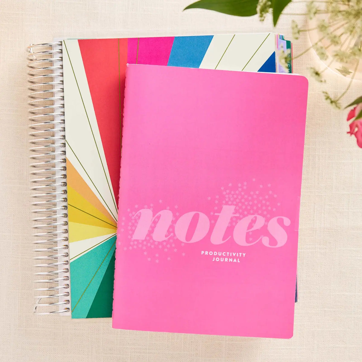 Erin Condren Petite Journal: Pink productivity notebook beside a coiled planner