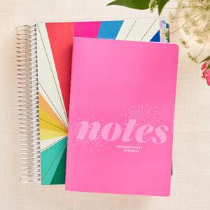 Erin Condren Petite Journal: Pink productivity notebook beside a coiled planner