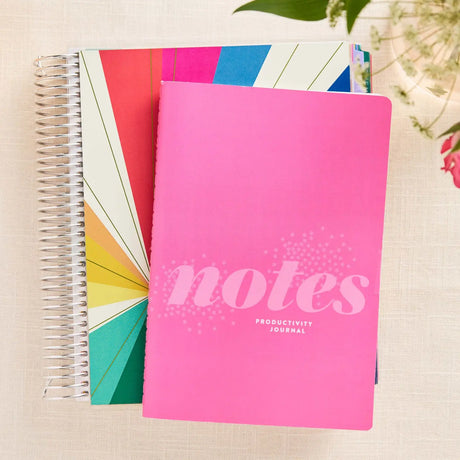 Erin Condren Petite Journal: Pink productivity notebook beside a coiled planner
