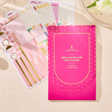 Erin Condren sticker book: Pink sticker book with several sheets spread behind it