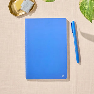 Erin Condren Petite Journal: Closed Royal Blue journal beside a blue pen