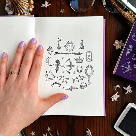 Notebook page stamped with Fantasy & Fiction Stamp Set with various designs